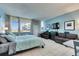 Bright main bedroom featuring tile floors, sofa, TV, and coastal views from the expansive windows at 611 Destiny Dr # 304, Ruskin, FL 33570