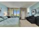 Stylish main bedroom featuring tile floors, sofa, TV, and coastal views from the expansive windows at 611 Destiny Dr # 304, Ruskin, FL 33570