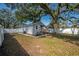 Expansive fenced backyard with shade tree, offering privacy and outdoor living space at 6907 N 12Th St, Tampa, FL 33604