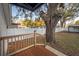 Charming backyard features a wooden deck, privacy fence, and mature shade tree at 6907 N 12Th St, Tampa, FL 33604