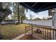 Charming backyard features a wooden deck, privacy fence, and mature shade tree at 6907 N 12Th St, Tampa, FL 33604