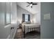Cozy bedroom with a ceiling fan, gray walls, a window, and a comfortable-looking bed at 6907 N 12Th St, Tampa, FL 33604