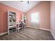 Bright bedroom features vaulted ceiling, wood-look floors, and versatile built-in shelving and desk space at 6907 N 12Th St, Tampa, FL 33604