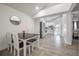 Open dining area with a wooden table, flowing into the kitchen and living spaces at 6907 N 12Th St, Tampa, FL 33604