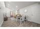 Spacious dining area connected to the living room, featuring modern lighting and hardwood floors at 6907 N 12Th St, Tampa, FL 33604