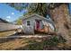 Charming single-story home featuring a vibrant pink door and a well-maintained yard at 6907 N 12Th St, Tampa, FL 33604