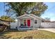 Charming single-story home with a bright pink front door and well-maintained landscaping at 6907 N 12Th St, Tampa, FL 33604