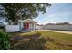 Inviting front yard with a well-manicured lawn and a charming home with a bright pink door at 6907 N 12Th St, Tampa, FL 33604