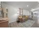 Cozy living room with neutral tones, a comfortable couch, and views into the dining area and kitchen at 6907 N 12Th St, Tampa, FL 33604