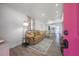 Open-concept living room featuring wood floors and seamless flow into the kitchen and dining area at 6907 N 12Th St, Tampa, FL 33604