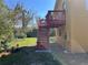 View of the backyard showing the deck with stairs and the yard at 7111 N 53Rd St, Tampa, FL 33617