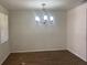 Dining room with wood-look floors and a modern chandelier at 7111 N 53Rd St, Tampa, FL 33617