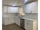 Modern kitchen with white cabinets, stainless steel appliances, and subway tile backsplash at 7111 N 53Rd St, Tampa, FL 33617