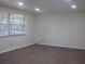 Bright living room featuring hardwood floors, white walls, and a large picture window for ample natural light at 7111 N 53Rd St, Tampa, FL 33617