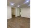 Spacious living room featuring hardwood floors, neutral paint, modern lighting, and access to other rooms at 7111 N 53Rd St, Tampa, FL 33617