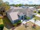An aerial view of a light blue single-story home with palm trees and a driveway at 715 45Th E St, Bradenton, FL 34208