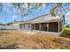 The backyard features a patio, a screened in porch, grey stucco walls, and an adjacent wood fence at 715 45Th E St, Bradenton, FL 34208