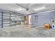 View of the garage with a concrete floor, storage shelves, a door to the house, and a water heater at 715 45Th E St, Bradenton, FL 34208