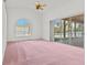Bright bedroom with vaulted ceiling, large arched window and sliding doors to the lanai at 726 Hidden Lake Dr, Tarpon Springs, FL 34689