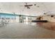 Spacious ballroom featuring ceiling fans, large windows, and a stage with a piano at 7400 Sun Island Drive S # 712, South Pasadena, FL 33707