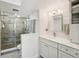 Bright bathroom features gray cabinets, modern fixtures, stylish tiling and walk-in shower at 7400 Sun Island Drive S # 712, South Pasadena, FL 33707