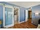 Bedroom leads to bathroom featuring sliding barn door, modern fixtures, and walk-in shower at 7400 Sun Island Drive S # 712, South Pasadena, FL 33707