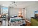 Bright bedroom with desk, ceiling fan, and access to a large window with lots of light and a water view at 7400 Sun Island Drive S # 712, South Pasadena, FL 33707