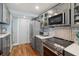 Well-lit kitchen showcasing gray cabinets, stainless steel appliances and wood floor at 7400 Sun Island Drive S # 712, South Pasadena, FL 33707