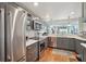 Modern kitchen featuring stainless steel appliances, white countertops, and a view into the living area at 7400 Sun Island Drive S # 712, South Pasadena, FL 33707