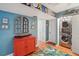 Hallway featuring front-loading washer and dryer, with storage and hardwood flooring throughout at 7400 Sun Island Drive S # 712, South Pasadena, FL 33707