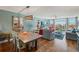 Living room with a rustic table, comfortable seating, scenic views, and an adjacent dining area at 7400 Sun Island Drive S # 712, South Pasadena, FL 33707