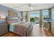 Bright primary bedroom featuring colorful bedding, waterfront views, and natural light at 7400 Sun Island Drive S # 712, South Pasadena, FL 33707
