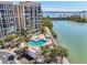 Enjoy waterfront views from this condo with a lovely in-ground pool and jacuzzi surrounded by mature palm trees at 7400 Sun Island Drive S # 712, South Pasadena, FL 33707