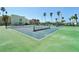Well-maintained tennis courts surrounded by lush greenery and palm trees at 7400 Sun Island Drive S # 712, South Pasadena, FL 33707