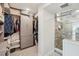 Bright walk-in closet featuring custom storage, cabinetry, and a seamless transition to a glass-enclosed shower at 7400 Sun Island Drive S # 712, South Pasadena, FL 33707