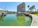 Condo and boat docks on the water with palm trees in the background at 7400 Sun Island Drive S # 712, South Pasadena, FL 33707