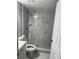 Bathroom features tiled shower with marble look, new fixtures, and white vanity at 7909 N Packwood Ave, Tampa, FL 33604
