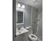 Bathroom features tiled shower with marble look, new fixtures, and white vanity at 7909 N Packwood Ave, Tampa, FL 33604