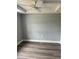 A bedroom with gray vinyl floors, neutral walls, white trim, and a ceiling fan at 7909 N Packwood Ave, Tampa, FL 33604