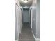 Hallway with neutral gray paint, wood-look flooring, and storage closet at 10367 Councils Way, Temple Terrace, FL 33617