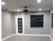 Living room with neutral gray paint, wood-look flooring, ceiling fan, and a back door at 10367 Councils Way, Temple Terrace, FL 33617