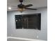 Living room with neutral gray paint, wood-look flooring, ceiling fan, and a window at 10367 Councils Way, Temple Terrace, FL 33617