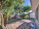 Spacious backyard with brick patio area, surrounded by lush greenery and a wooden fence at 10408 Rosemount Dr, Tampa, FL 33624