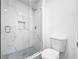Modern bathroom featuring a glass-enclosed shower with marble tile surround and rain shower head at 10408 Rosemount Dr, Tampa, FL 33624