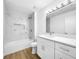 Contemporary bathroom with marble tile surround, shower-tub, and vanity with drawers at 10408 Rosemount Dr, Tampa, FL 33624