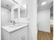Bathroom with a quartz countertop, a mirror, and laminate flooring at 10408 Rosemount Dr, Tampa, FL 33624