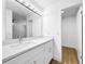 Bright bathroom with a large mirror, white cabinets, and modern fixtures at 10408 Rosemount Dr, Tampa, FL 33624