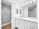Modern bathroom featuring a marble-tiled shower and a large mirror above the vanity at 10408 Rosemount Dr, Tampa, FL 33624