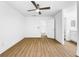 Bright bedroom with a ceiling fan and entrances to a bathroom and closet at 10408 Rosemount Dr, Tampa, FL 33624