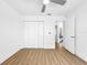 Bedroom with ceiling fan, laminate flooring, and double door closet at 10408 Rosemount Dr, Tampa, FL 33624